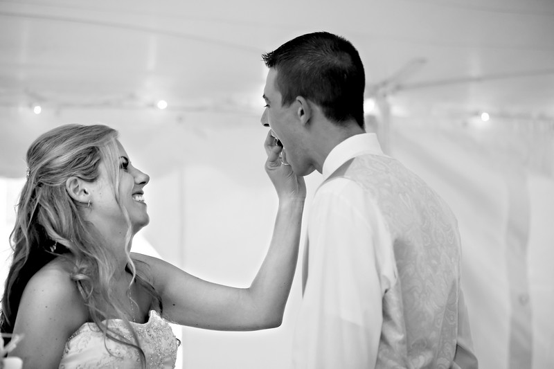 Bride and groom cutting the cake by New England Wedding Photographer